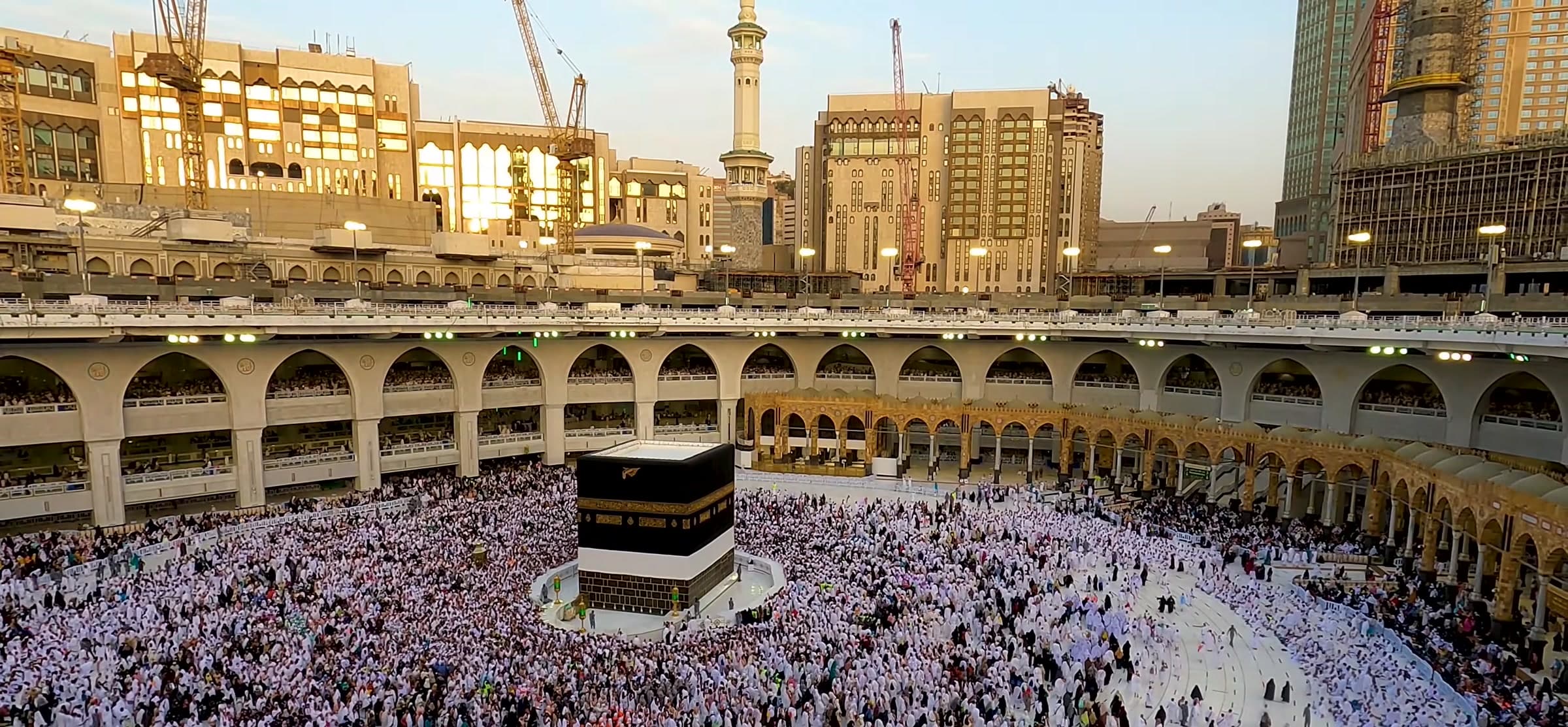 Masjid al-Haram at golden hour with the Ka'bah at the centre of the courtyard.
